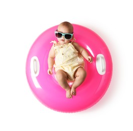 Photo of Cute little baby in sunglasses with inflatable ring on white background, top view