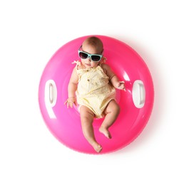Photo of Cute little baby in sunglasses with inflatable ring on white background, top view