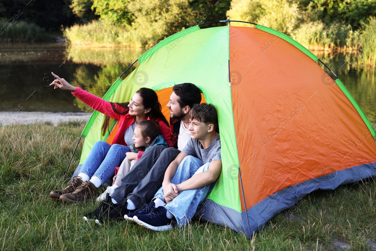 Happy family spending time together with camping tent outdoors Photo of Happy family spending time together with camping tent outdoors