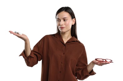 Photo of Woman choosing between glasses and contact lenses on white background