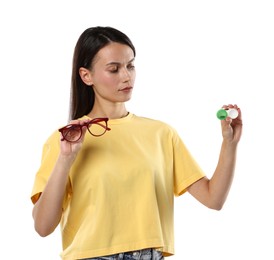 Photo of Woman choosing between glasses and contact lenses on white background