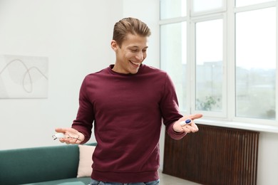 Photo of Man choosing between glasses and contact lenses indoors