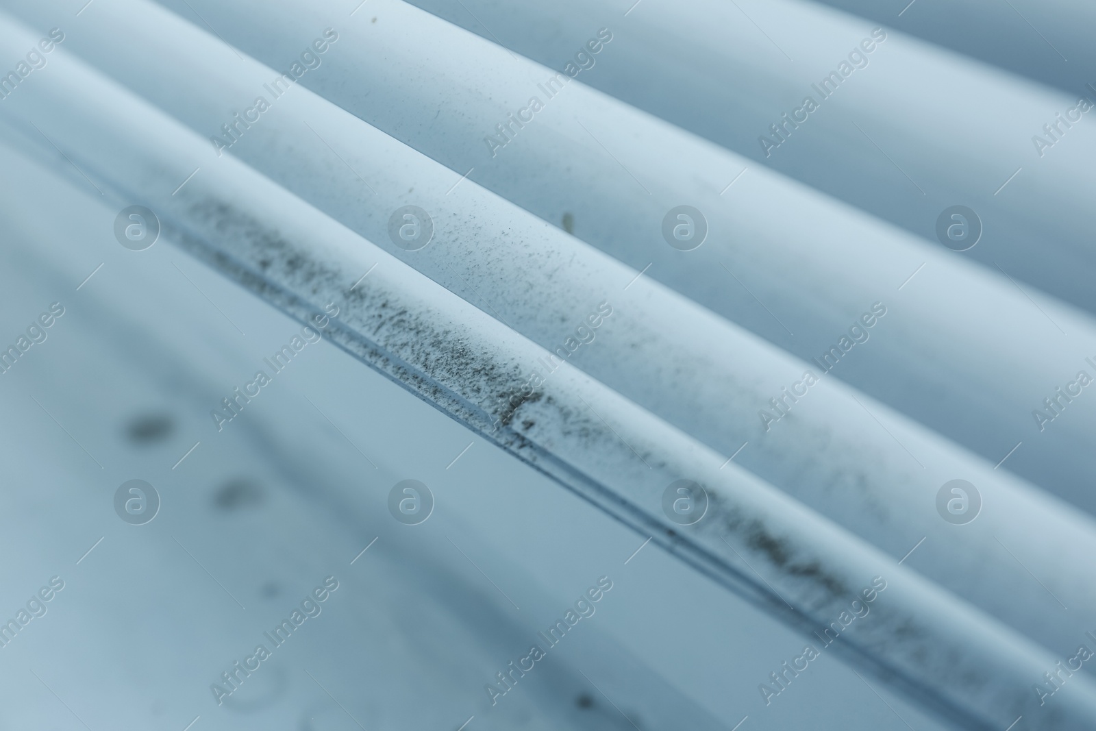 Photo of Window blinds covered with dust indoors, closeup