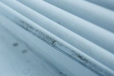 Photo of Window blinds covered with dust indoors, closeup