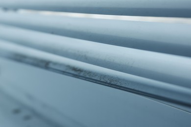 Photo of Window blinds covered with dust indoors, closeup
