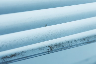 Photo of Window blinds covered with dust indoors, closeup