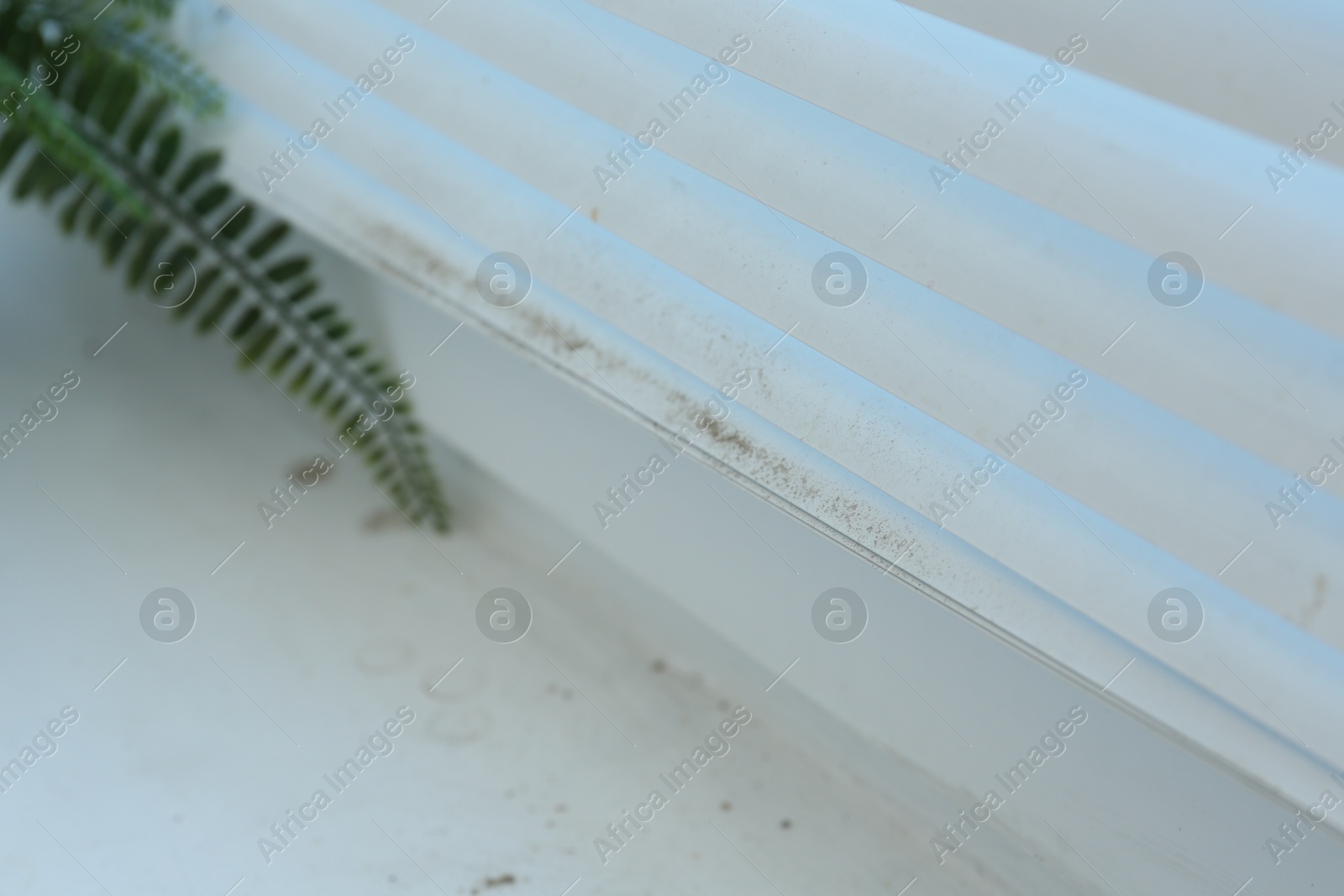 Photo of Window blinds covered with dust indoors, closeup