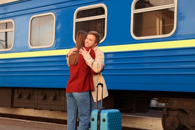 Photo of Goodbye. Lovely couple hugging on platform of railway station
