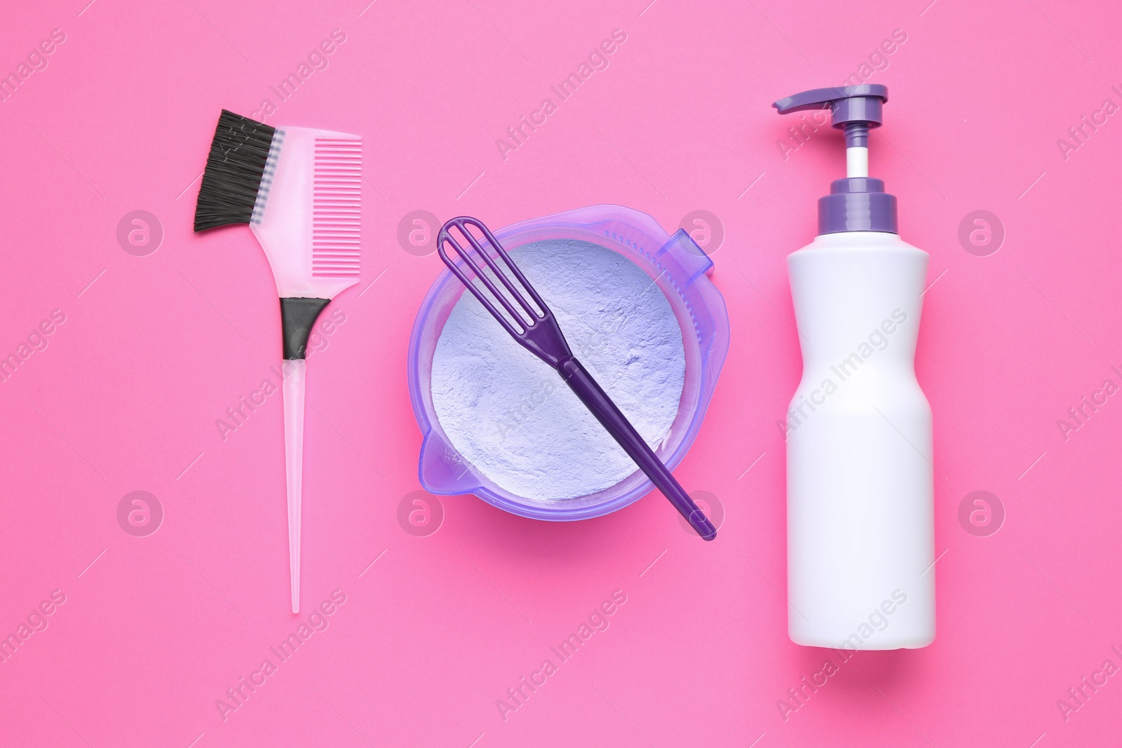 Photo of Care cosmetic product for blonde hair in bowl and hairdresser's tools on pink background, flat lay