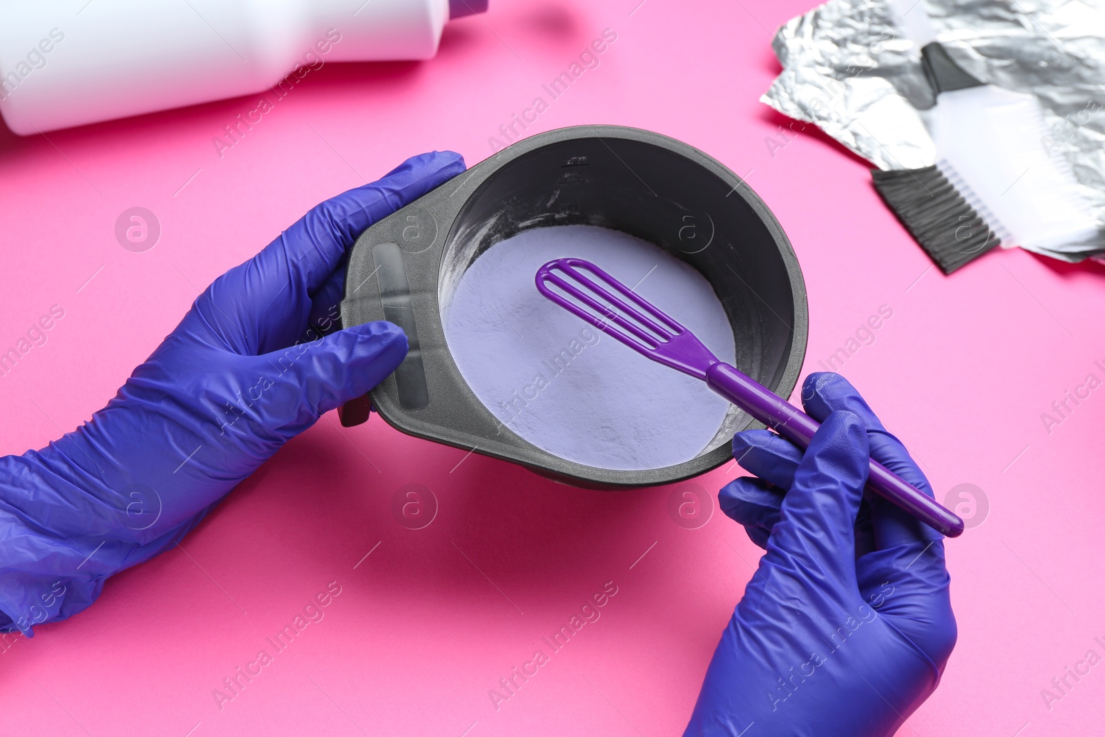 Photo of Woman making hair care product for blonde hair on pink background, closeup