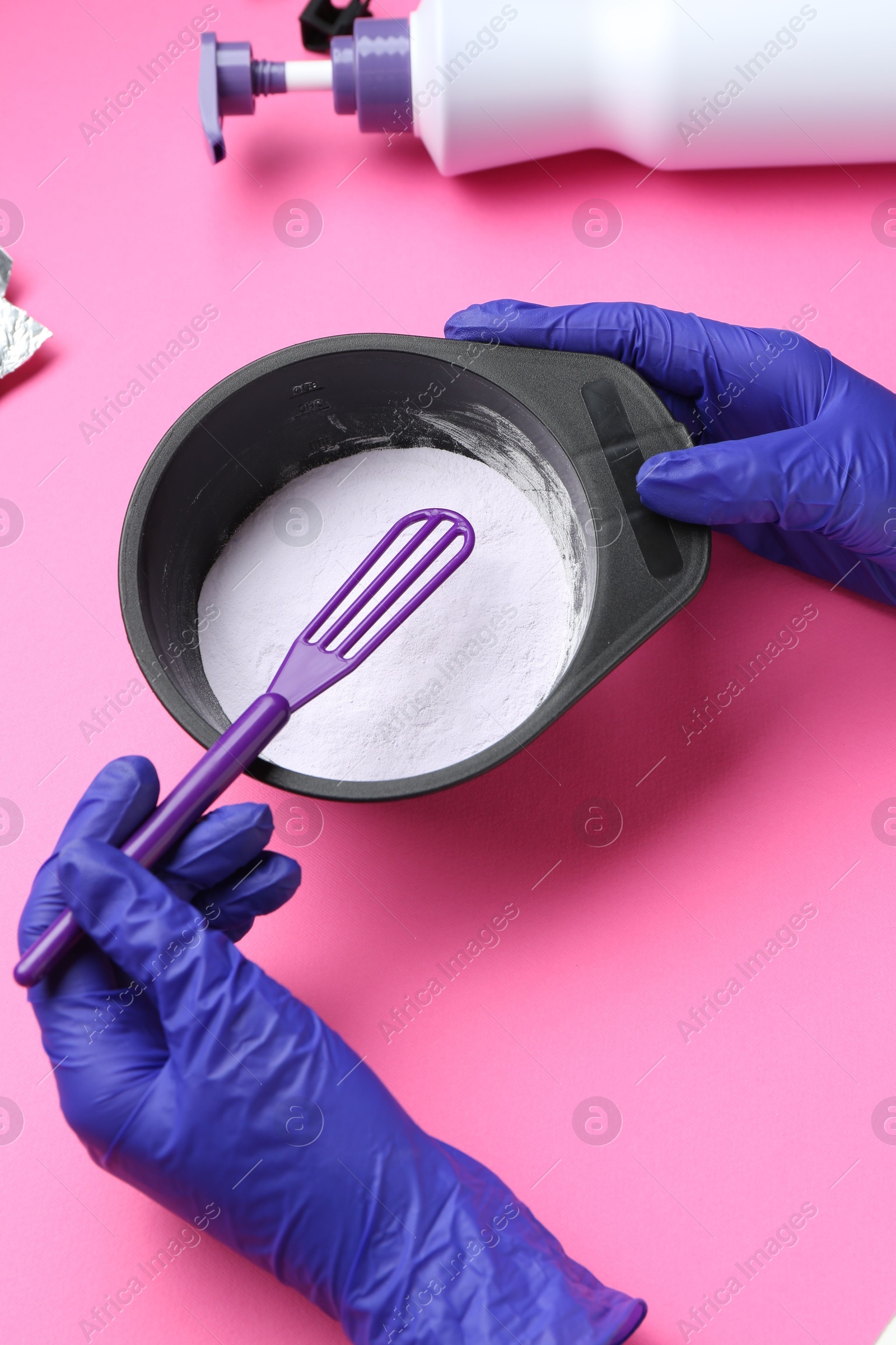 Photo of Woman making hair care product for blonde hair on pink background, closeup