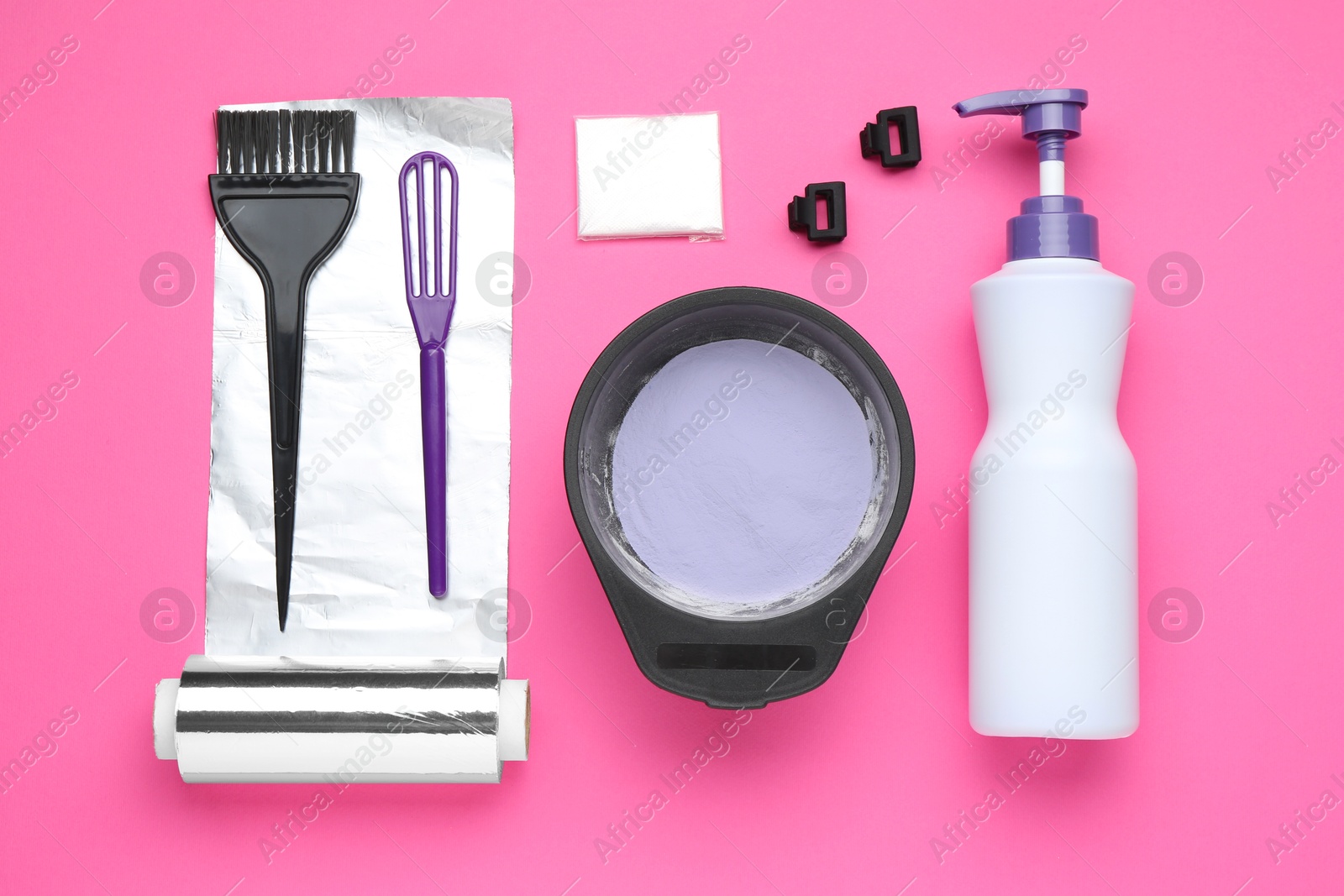 Photo of Care cosmetic product for blonde hair in bowl and hairdresser's tools on pink background, flat lay