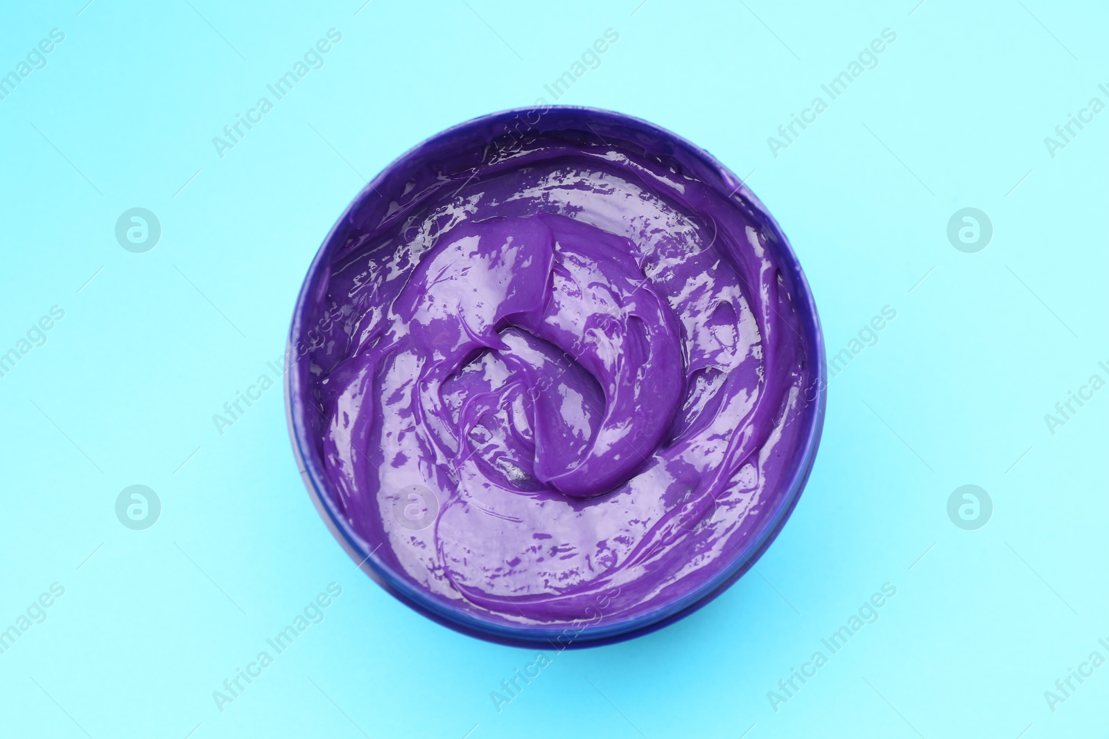 Care cosmetic product for blonde hair in jar on light blue background, top view Photo of Care cosmetic product for blonde hair in jar on light blue background, top view