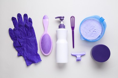 Photo of Hair care product for blonde hair and hairdresser's tools on white background, flat lay