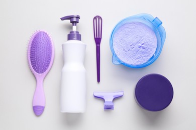 Photo of Hair care product for blonde hair and hairdresser's tools on white background, flat lay