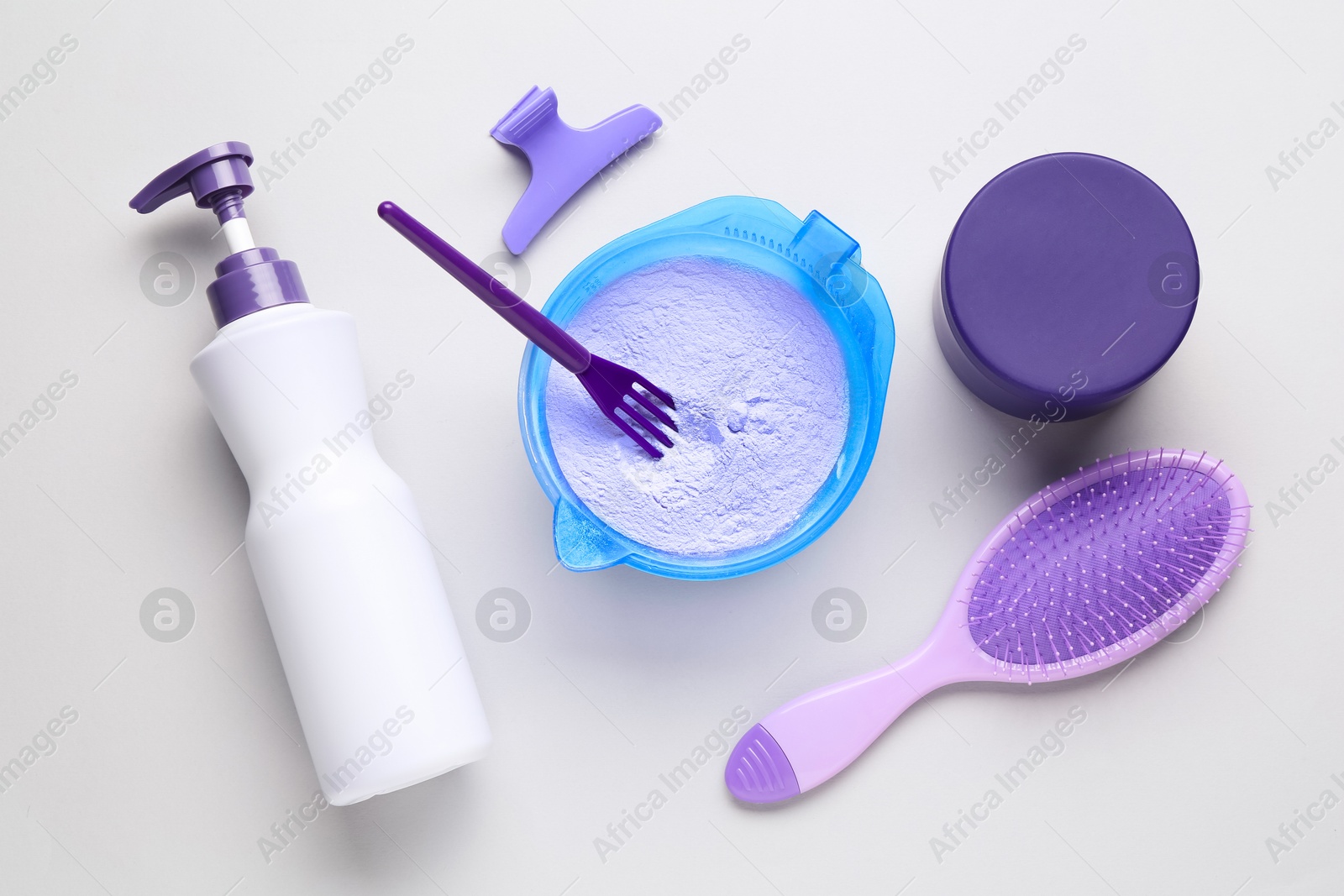 Photo of Hair care product for blonde hair and hairdresser's tools on white background, flat lay