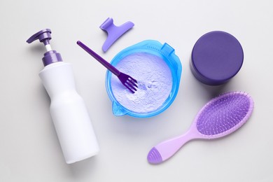 Photo of Hair care product for blonde hair and hairdresser's tools on white background, flat lay