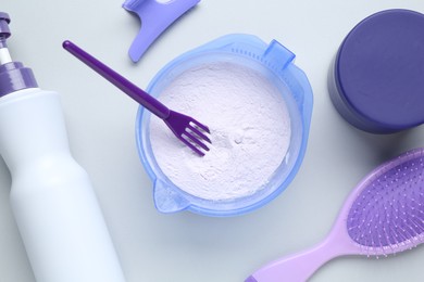 Photo of Hair care product for blonde hair and hairdresser's tools on white background, flat lay