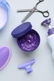 Photo of Hair care product for blonde hair and hairdresser's tools on white background, flat lay