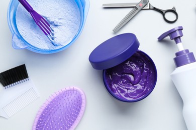Photo of Hair care product for blonde hair and hairdresser's tools on white background, flat lay