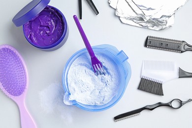 Photo of Hair care product for blonde hair and hairdresser's tools on white background, flat lay