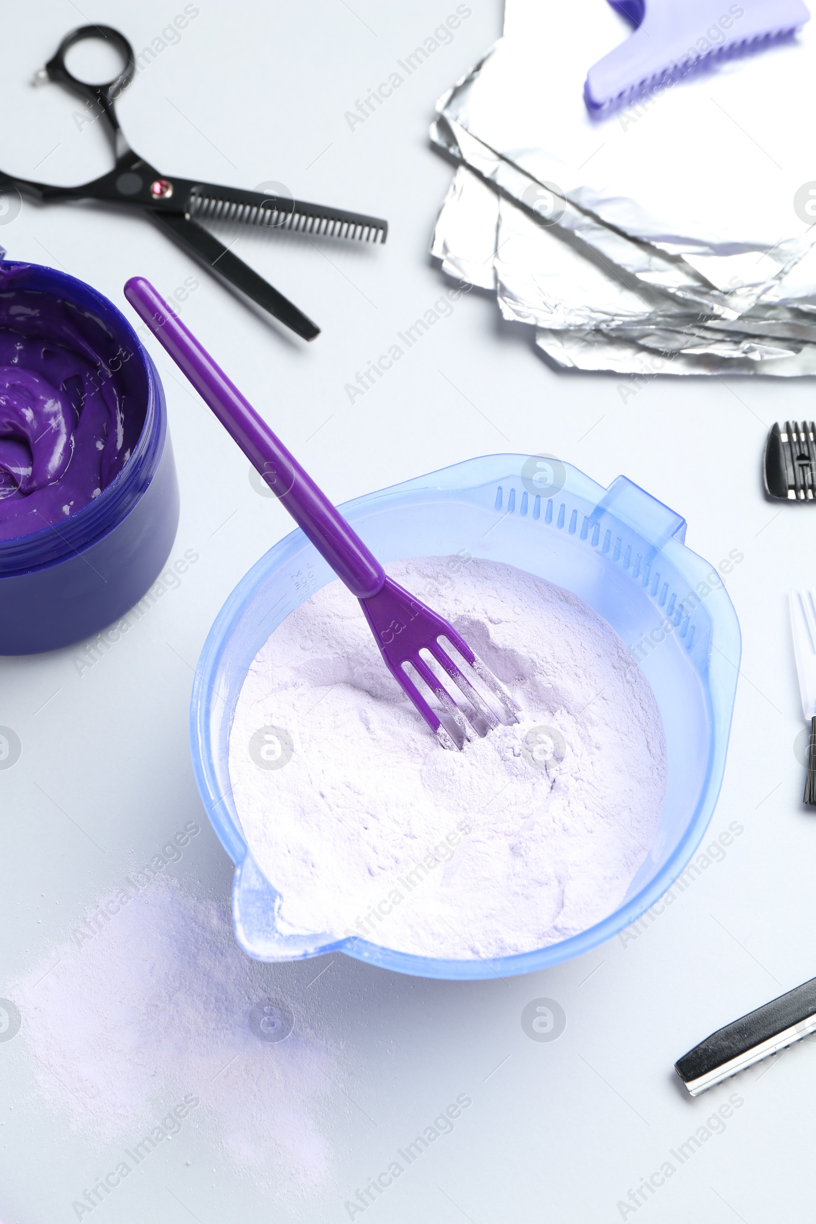 Photo of Hair care product for blonde hair and hairdresser's tools on white background, flat lay