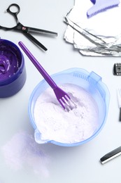 Photo of Hair care product for blonde hair and hairdresser's tools on white background, flat lay