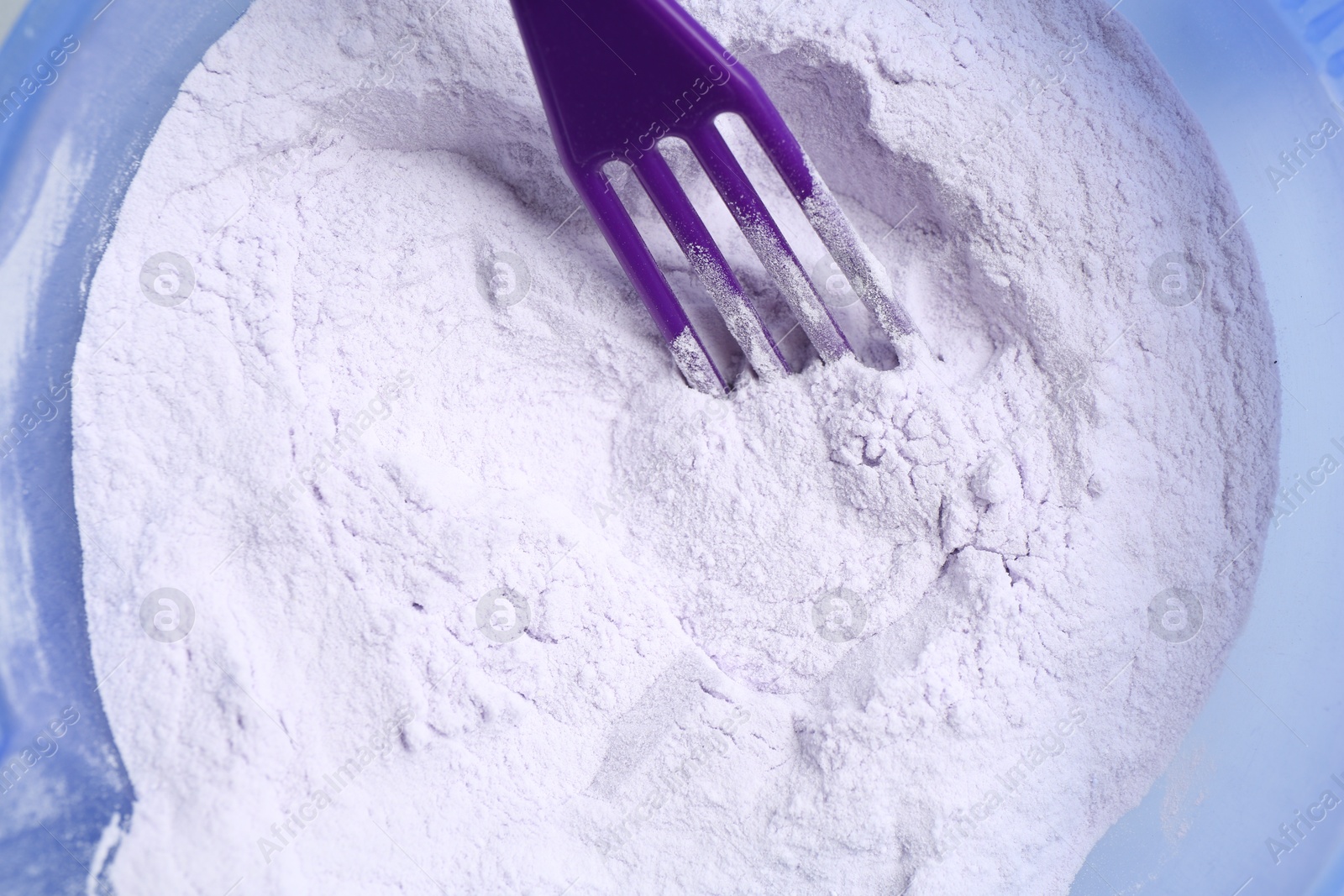 Photo of Hair care product for blonde hair and spatula in bowl, top view