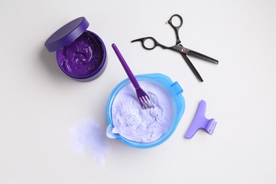 Photo of Hair care product for blonde hair and hairdresser's tools on white background, flat lay