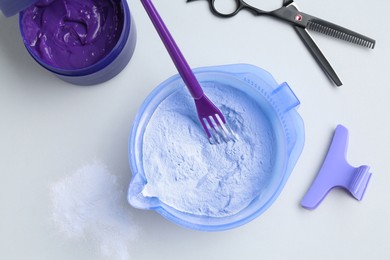 Photo of Hair care product for blonde hair and hairdresser's tools on white background, flat lay