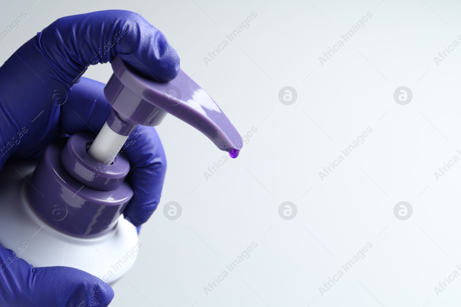 Photo of Woman with bottle of hair care product for blonde hair on white background, closeup. Space for text
