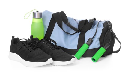 Photo of Stylish bag with sports equipment isolated on white