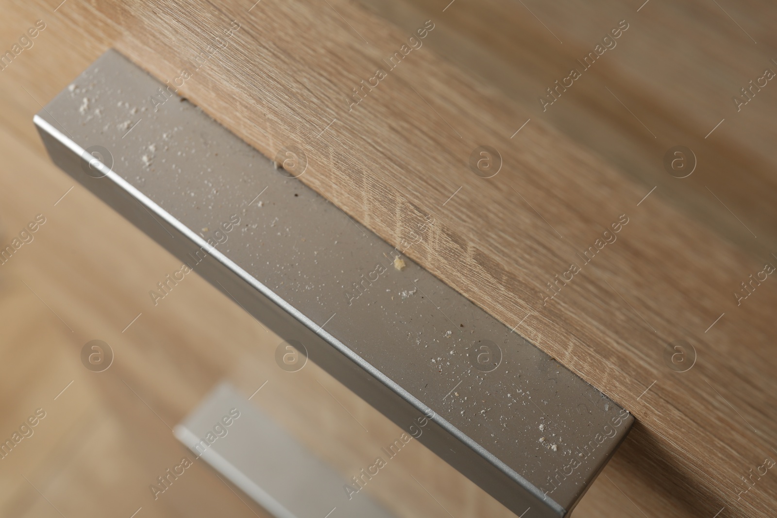 Handle of dresser covered with dust indoors, above view Photo of Handle of dresser covered with dust indoors, above view
