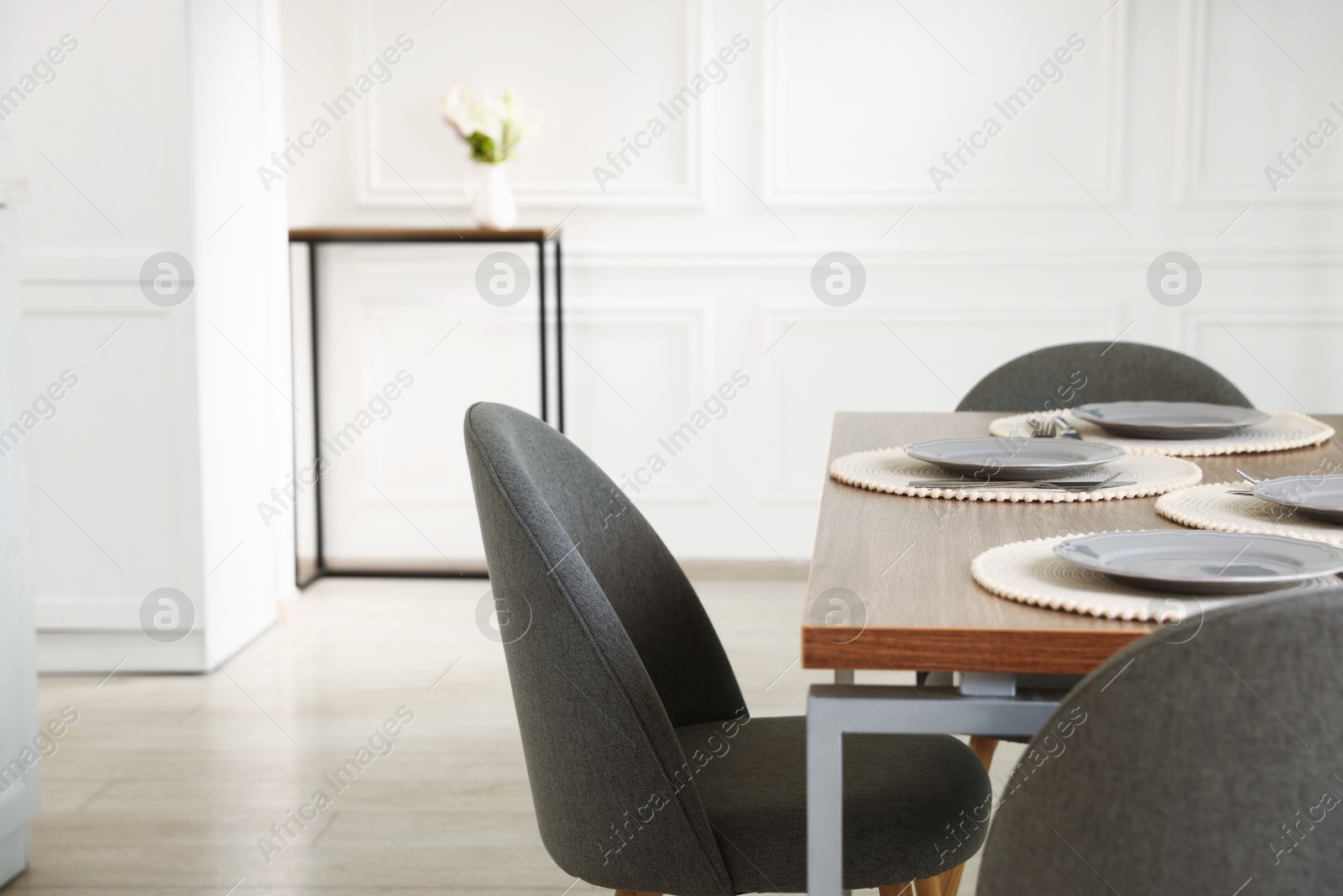 Photo of Stylish table setting and chairs in dining room. Interior design