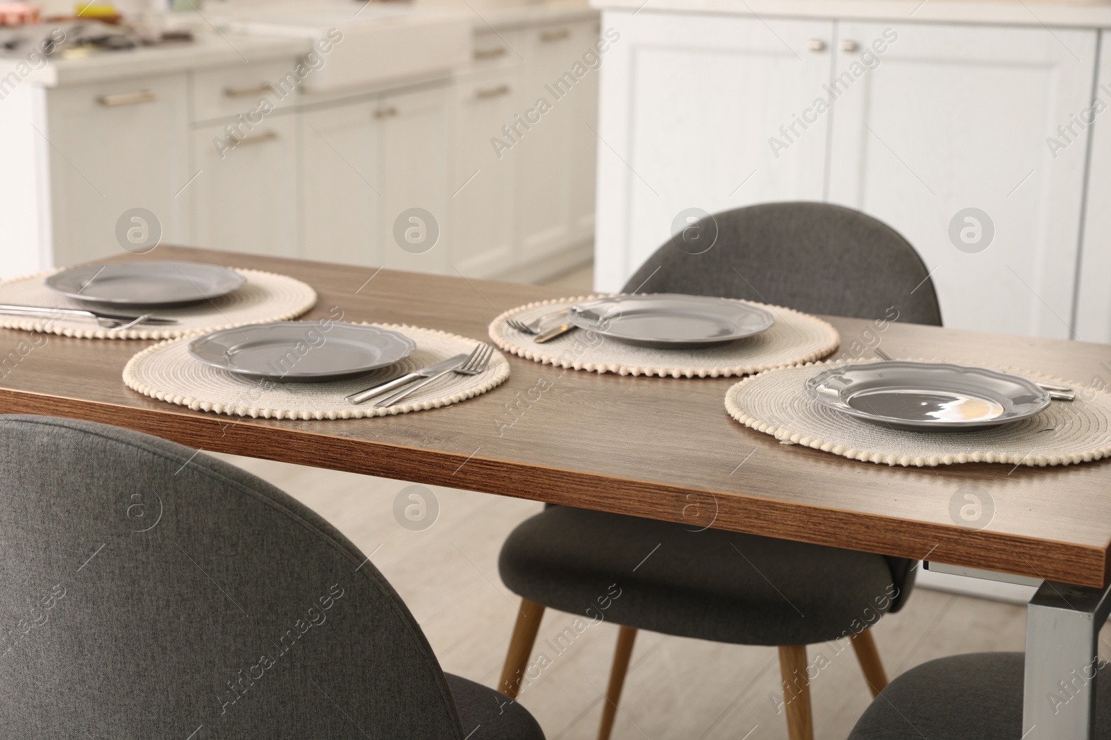 Photo of Stylish table setting and chairs in dining room. Interior design
