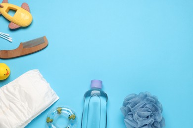 Photo of Baby bath accessories, diaper and toys on light blue background, flat lay. Space for text