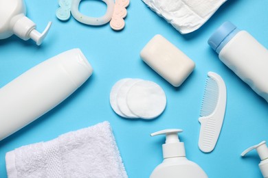 Photo of Baby bath accessories and care products on light blue background, flat lay