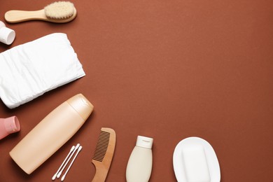 Photo of Baby bath accessories and cosmetic products on brown background, flat lay. Space for text