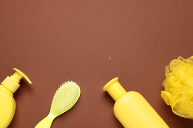 Photo of Baby bath accessories and cosmetic products on brown background, flat lay. Space for text