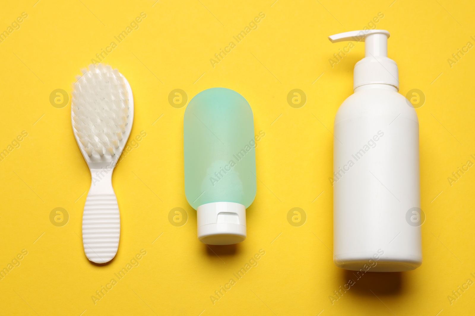 Photo of Baby bath necessities on yellow background, flat lay