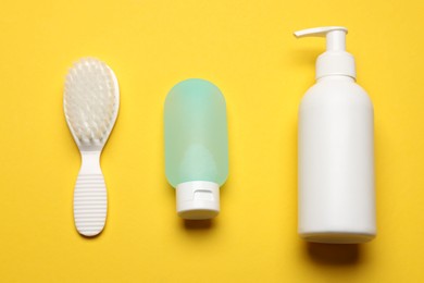 Photo of Baby bath necessities on yellow background, flat lay