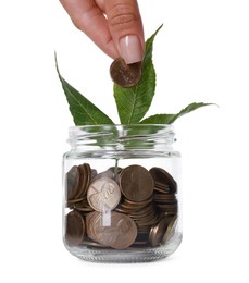 Photo of Woman putting coin into glass jar on white background, closeup