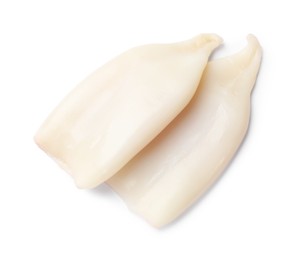 Photo of Pieces of raw squids isolated on white, top view