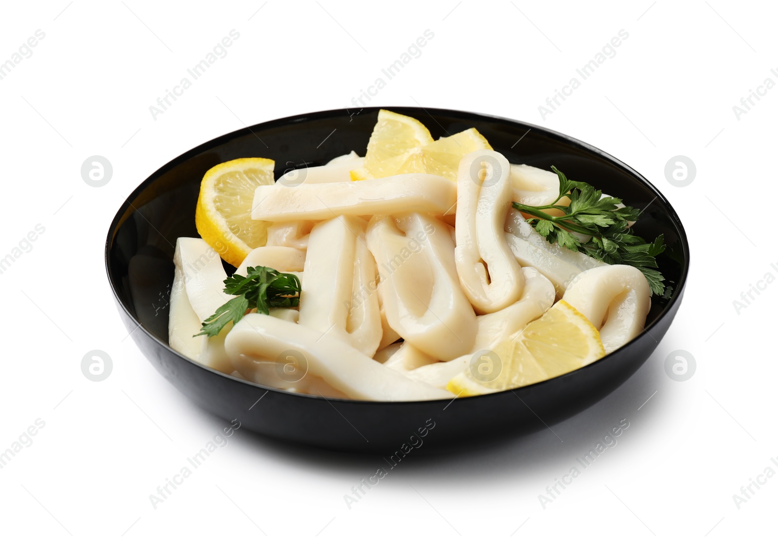 Photo of Raw squid rings, lemon and parsley in bowl isolated on white
