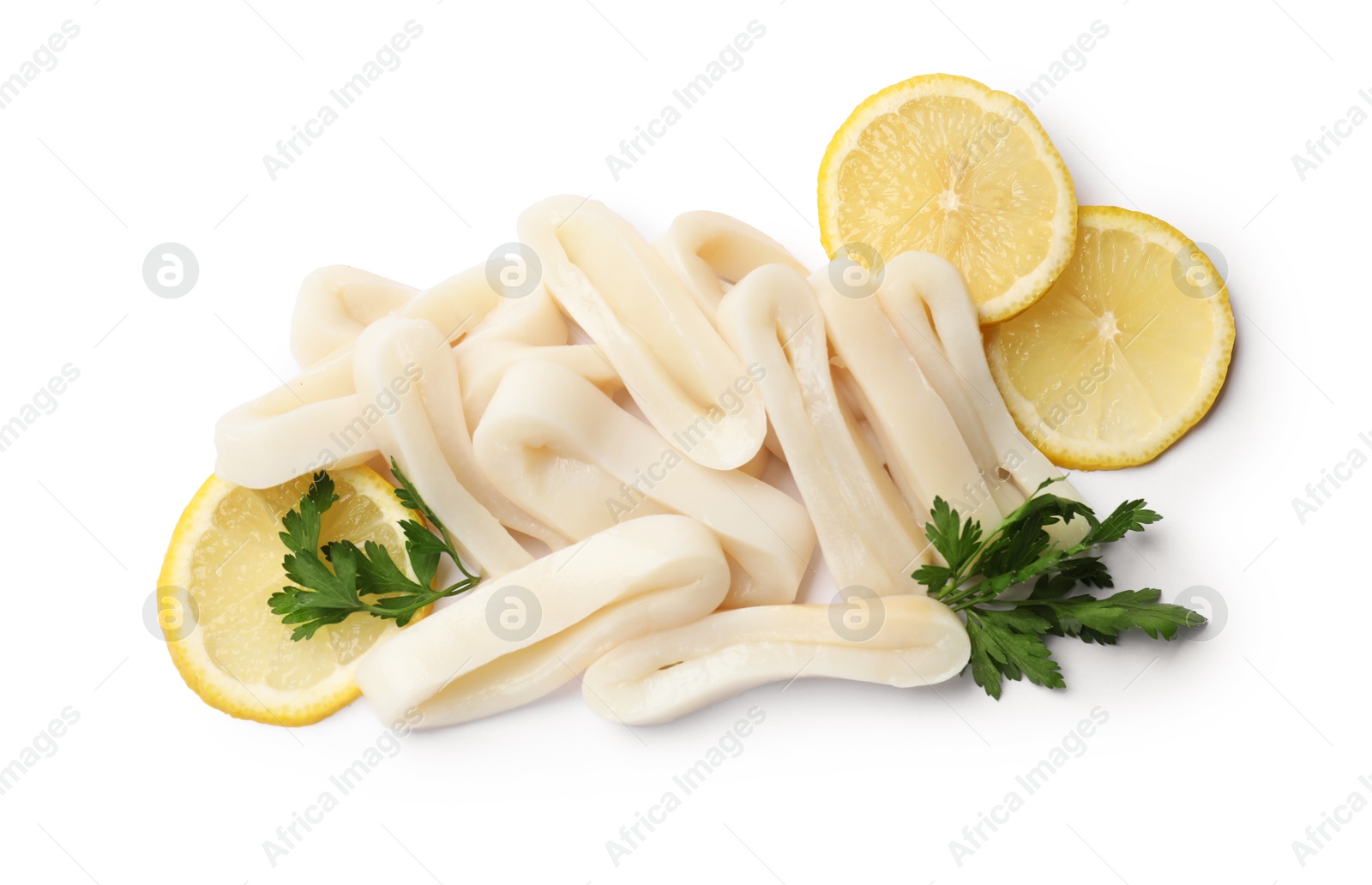 Photo of Pile of raw squid rings, lemon and parsley isolated on white, top view