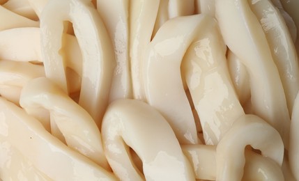 Photo of Raw squid rings as background, top view