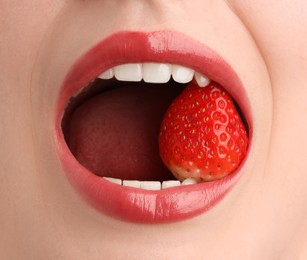 Photo of Woman with beautiful lips makeup and strawberry, closeup