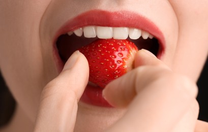 Photo of Woman with beautiful lips makeup and strawberry, closeup