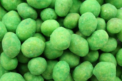 Photo of Tasty wasabi coated peanuts as background, closeup