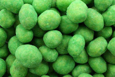 Photo of Tasty wasabi coated peanuts as background, closeup